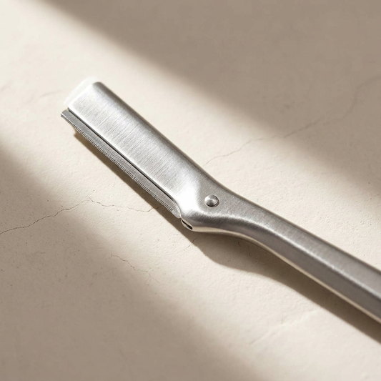 Macro of the stainless steel finish of the Lumi Editorial Dermaplaning Tool