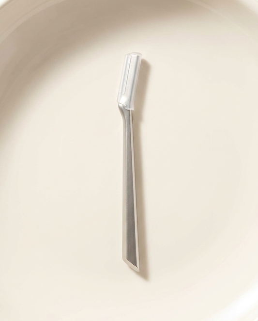 Dermaplaning Tool, bright morning light on warm porcelain
